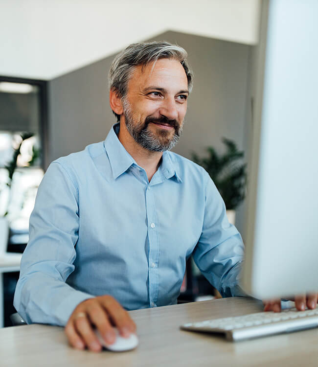 Man on computer looking accomplished