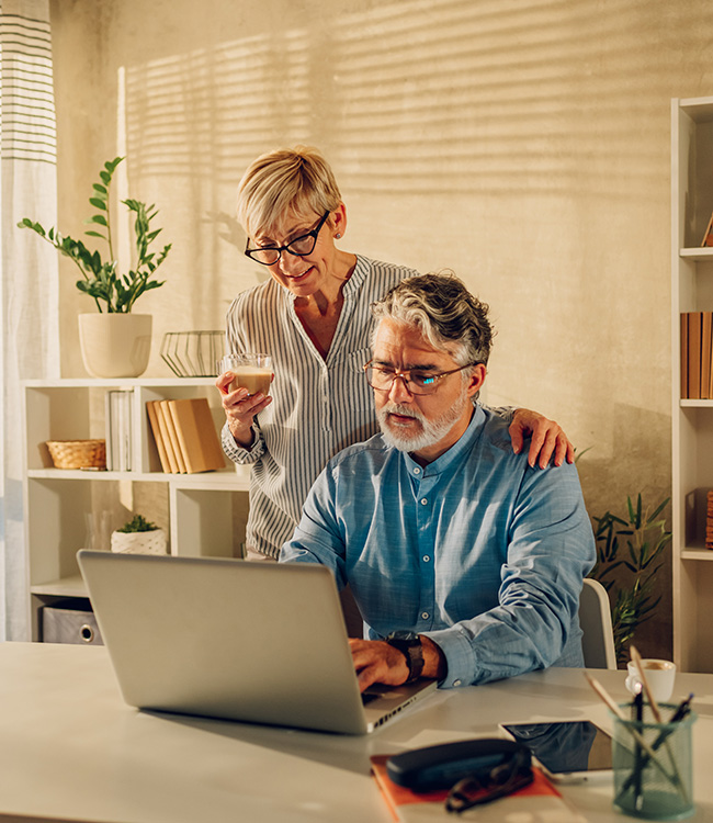 Senior couple using laptop